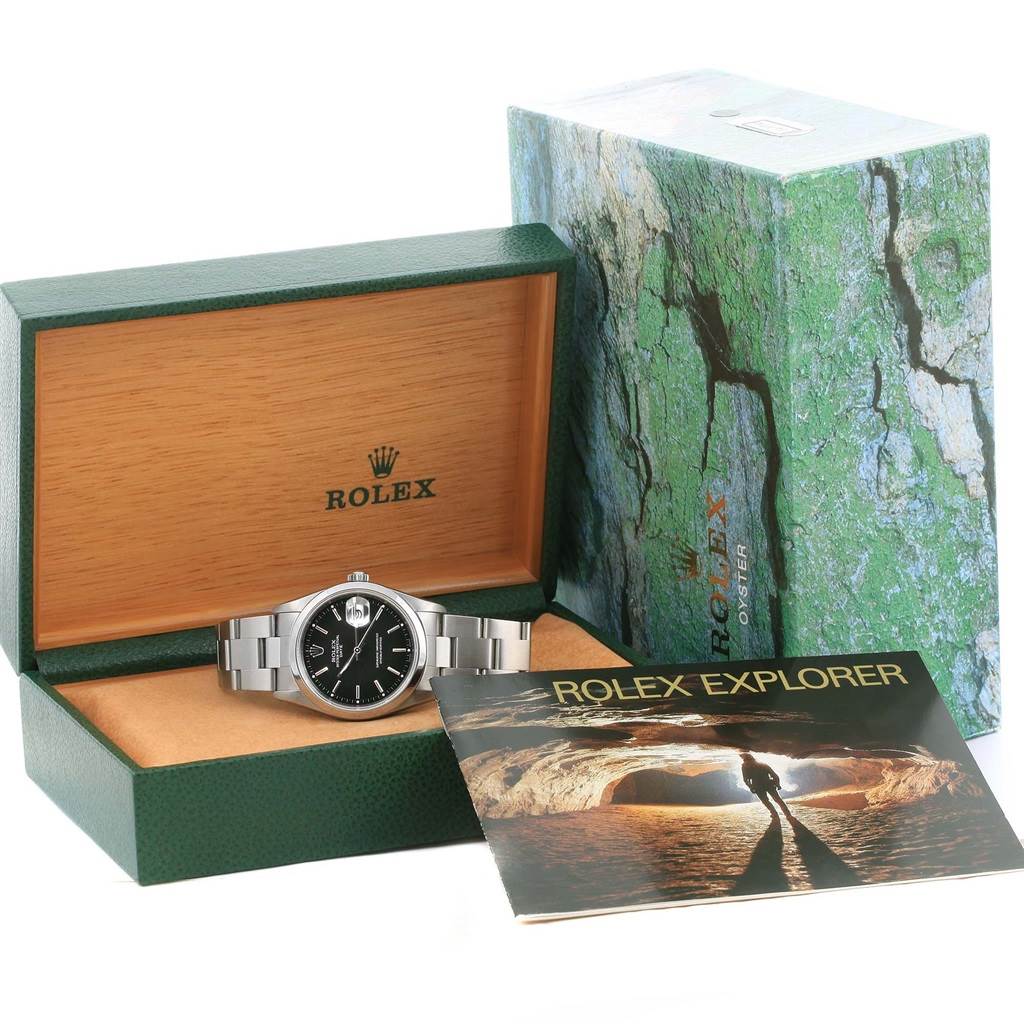 This photo shows a Rolex Date 15200 Men's Stainless Steel Black Dial 15200 Men's Stainless Steel Black Dial watch inside its open box, with the outer box and a Rolex Explorer booklet next to it.