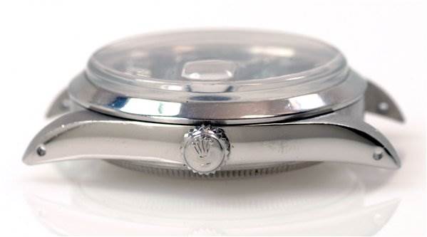 The image shows the side view of a Rolex Date 15000 Men's Stainless Steel  15000 Men's Stainless Steel  model watch, highlighting the case, crown, and lugs.