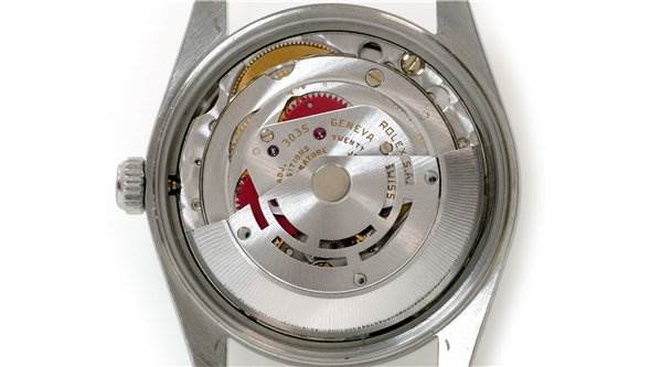 This image shows the internal mechanism of a Rolex Date 15000 Men's Stainless Steel  15000 Men's Stainless Steel  watch, viewed from the back with the caseback removed.