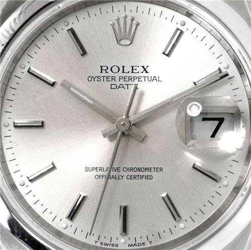 The image shows a close-up of the dial and hands of a Rolex Oyster Perpetual Date watch.