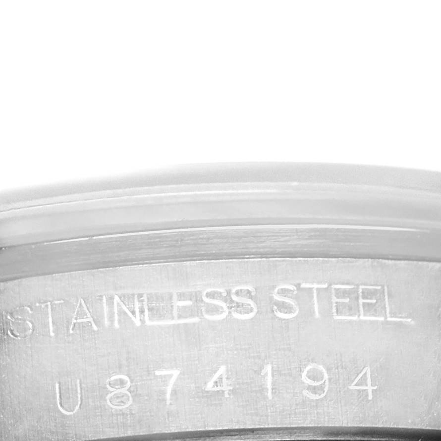 This image shows the engraved serial number and "STAINLESS STEEL" marking on the side of the Rolex Date 15200 Men's Stainless Steel Blue Dial 15200 Men's Stainless Steel Blue Dial model watch case.
