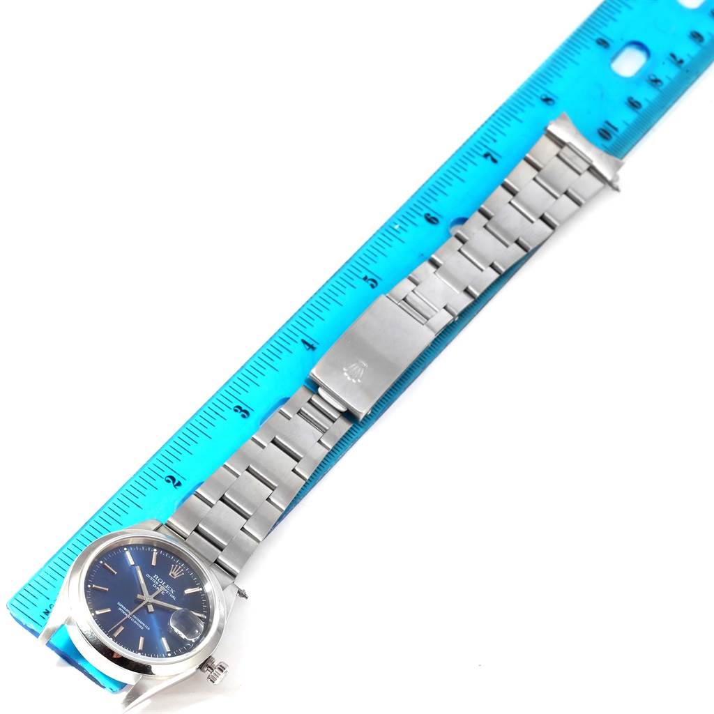 This image shows a top view of a Rolex Date 15200 Men's Stainless Steel Blue Dial 15200 Men's Stainless Steel Blue Dial model watch with its bracelet measured against a ruler.