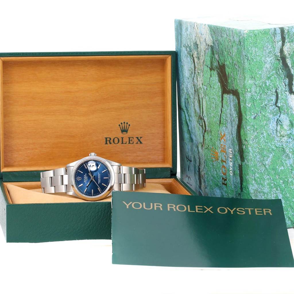 The image shows a Rolex Date 15200 Men's Stainless Steel Blue Dial 15200 Men's Stainless Steel Blue Dial model watch with its blue dial, original box, and warranty booklets displayed from the front angle.