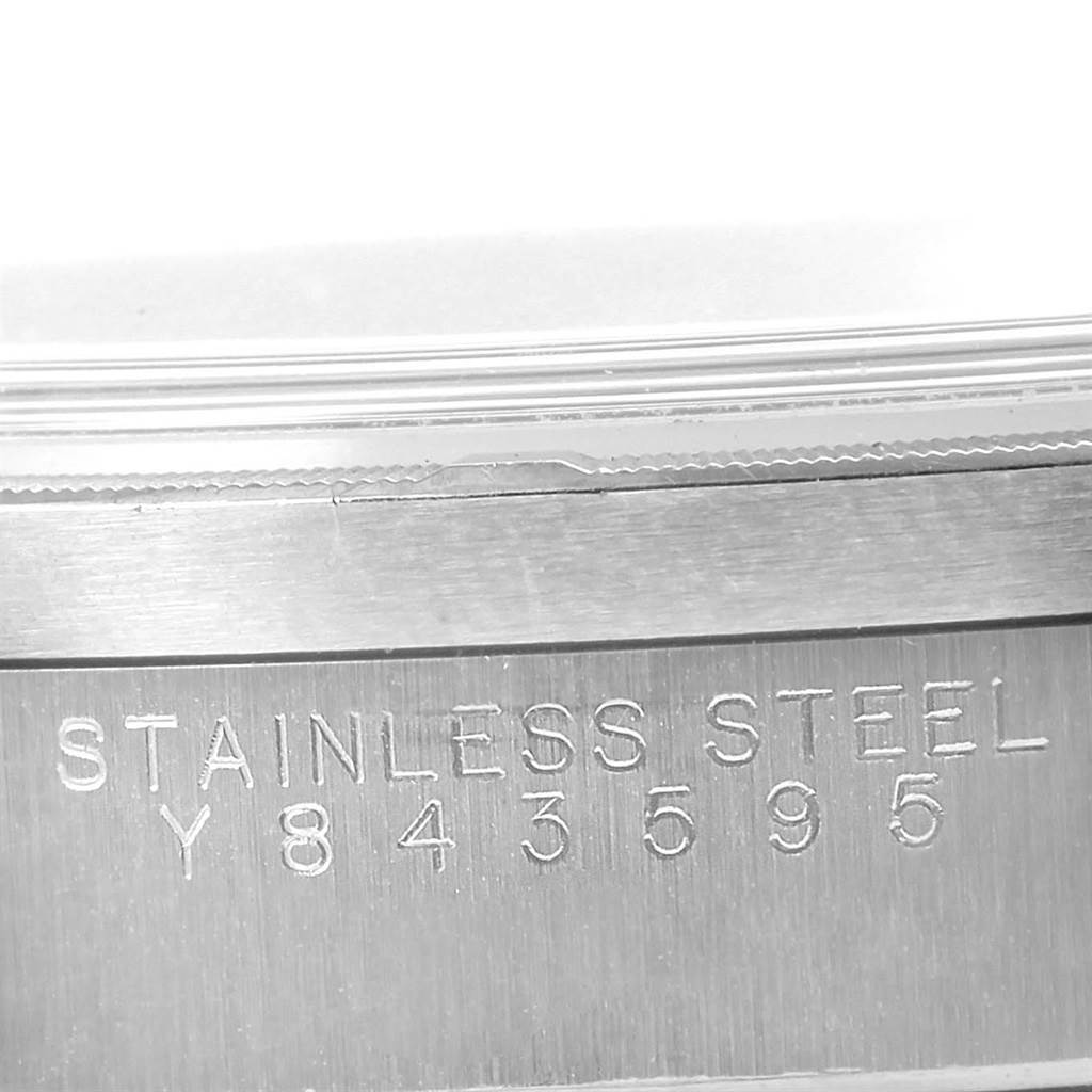 The image shows a close-up of the Rolex Date 15210 Men's Stainless Steel White Dial 15210 Men's Stainless Steel White Dial model's stainless steel casing with the serial number engraved.