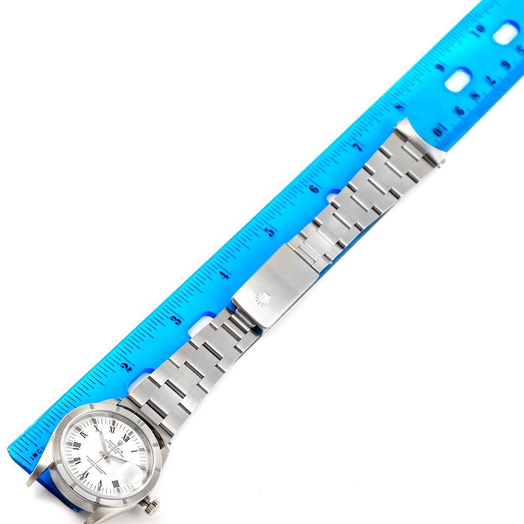 The image shows a Rolex Date 15210 Men's Stainless Steel White Dial 15210 Men's Stainless Steel White Dial model watch placed alongside a blue ruler for measurement, displaying the face, band, and clasp.