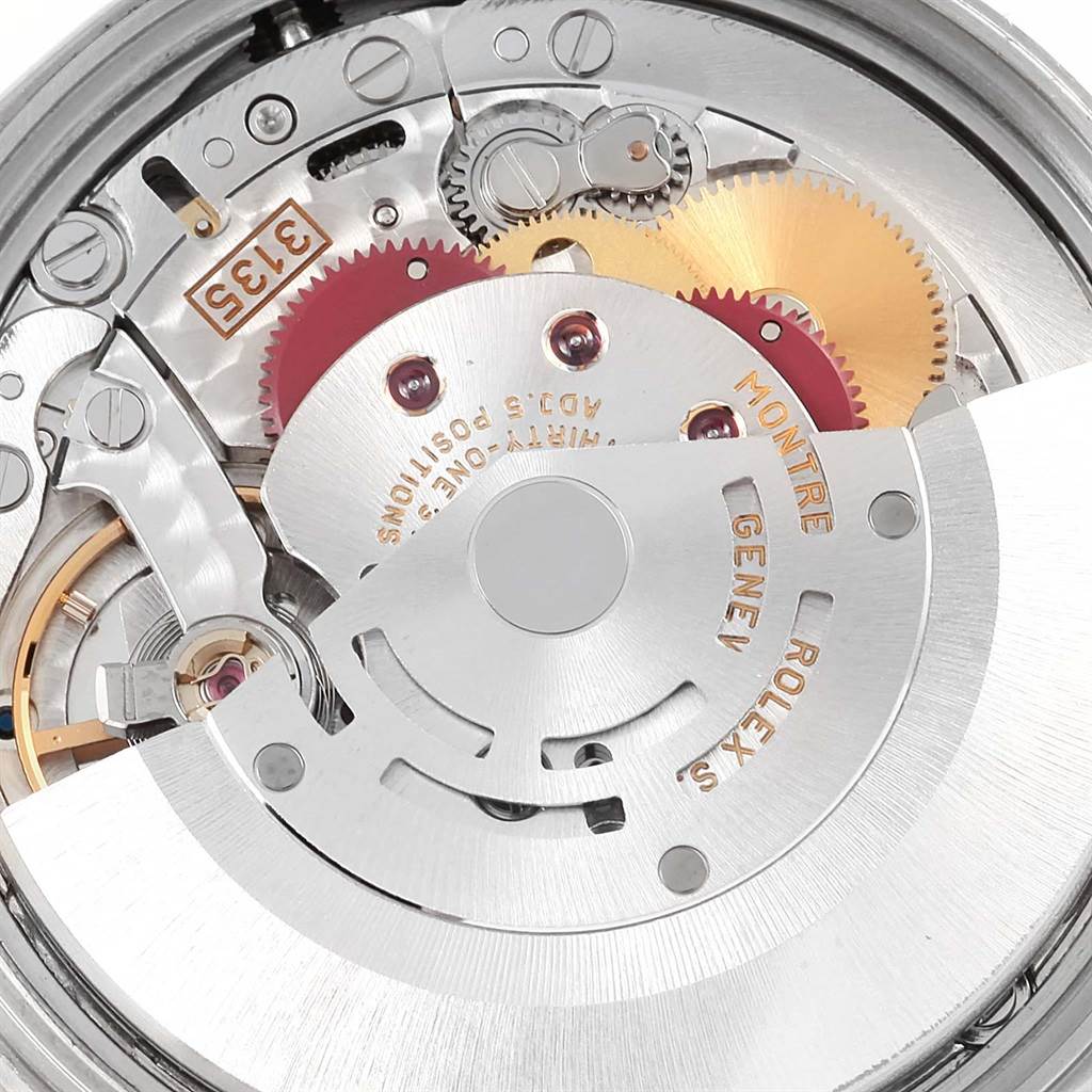 The image shows a close-up view of the internal mechanism of a Rolex Date 15210 Men's Stainless Steel White Dial 15210 Men's Stainless Steel White Dial model watch, highlighting its gears and rotor.