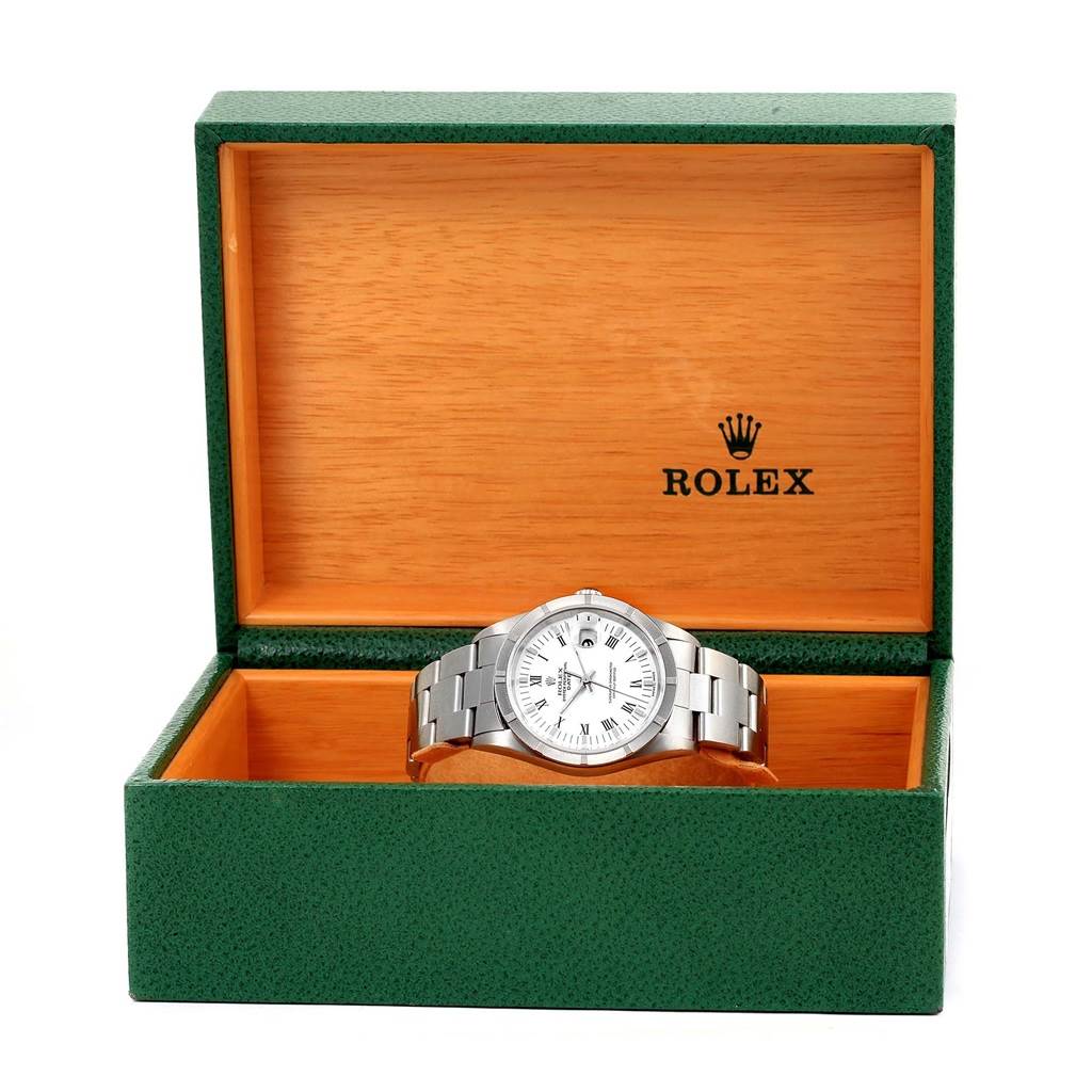The Rolex Date 15210 Men's Stainless Steel White Dial 15210 Men's Stainless Steel White Dial model watch is shown at eye level inside its green and wooden branded box.