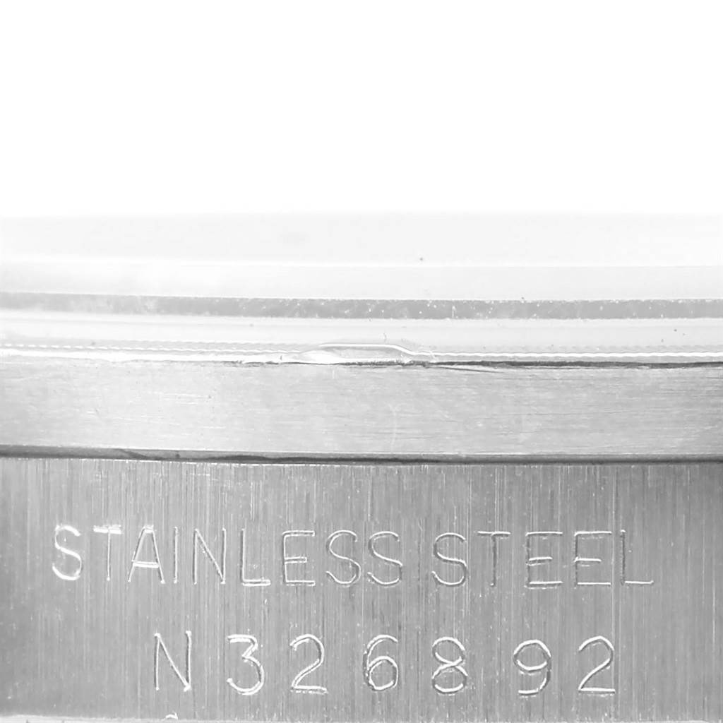 This image shows the engraved stainless steel case back of a Rolex Date 15210 Men's Stainless Steel Silver Dial 15210 Men's Stainless Steel Silver Dial model watch, including its serial number.