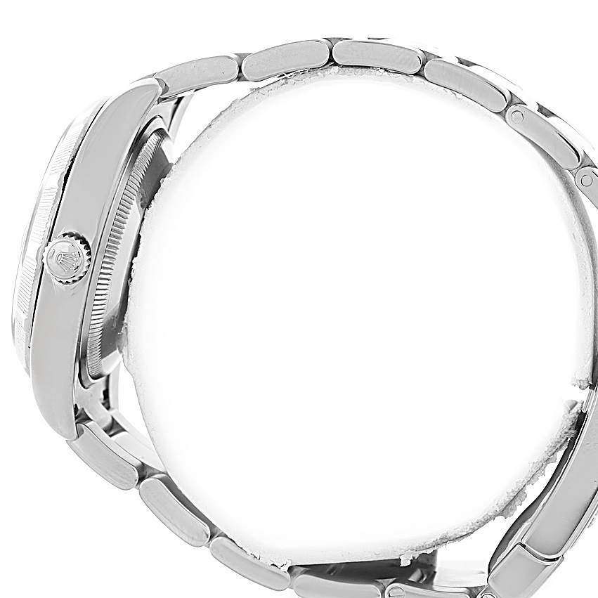 The image shows a side angle of a Rolex Date 115210 Men's Stainless Steel Blue Dial 115210 Men's Stainless Steel Blue Dial model watch, focusing on its case and the bracelet links.