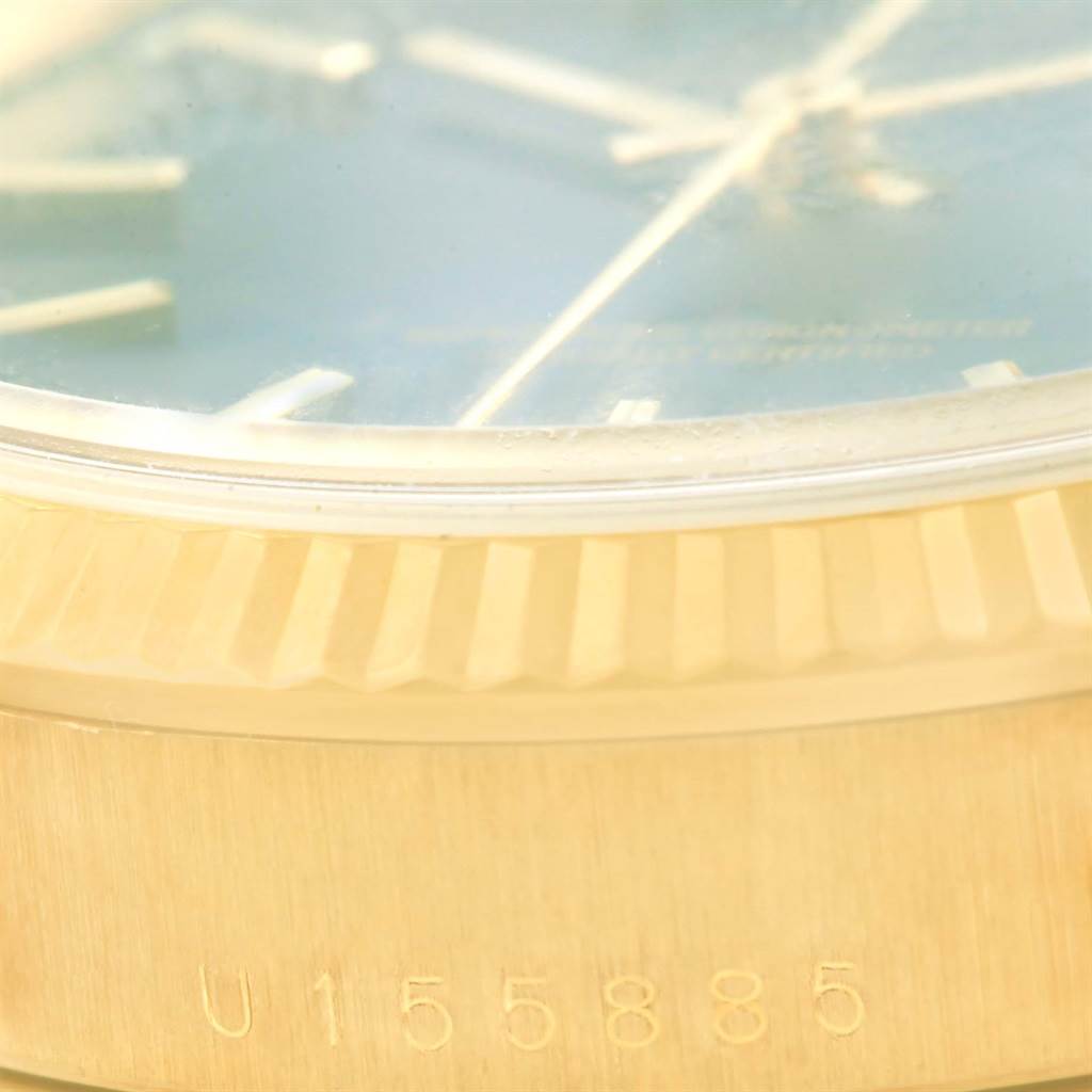 This image shows a close-up of the watch face, bezel, and serial number on the case side of a Rolex Date 15238 Men's Yellow Gold Blue Dial 15238 Men's Yellow Gold Blue Dial model.