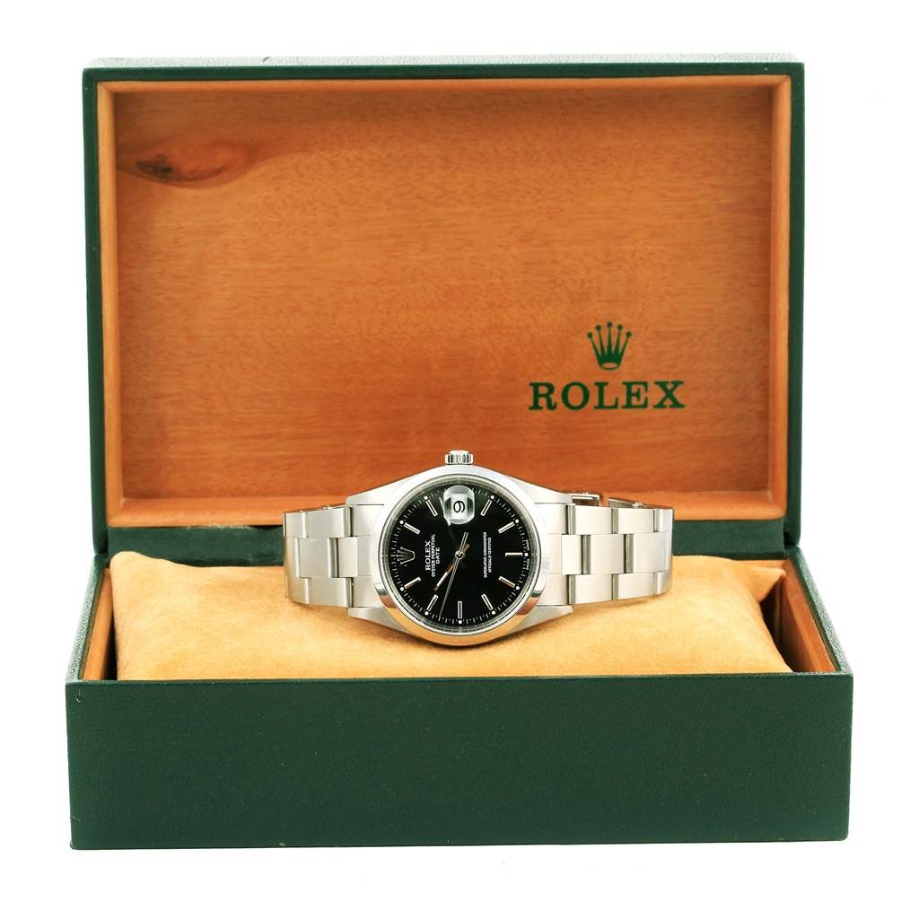 The Rolex Date 15200 Men's Stainless Steel Black Dial 15200 Men's Stainless Steel Black Dial model watch with a black dial and silver bracelet is shown from a front angle in its green box.