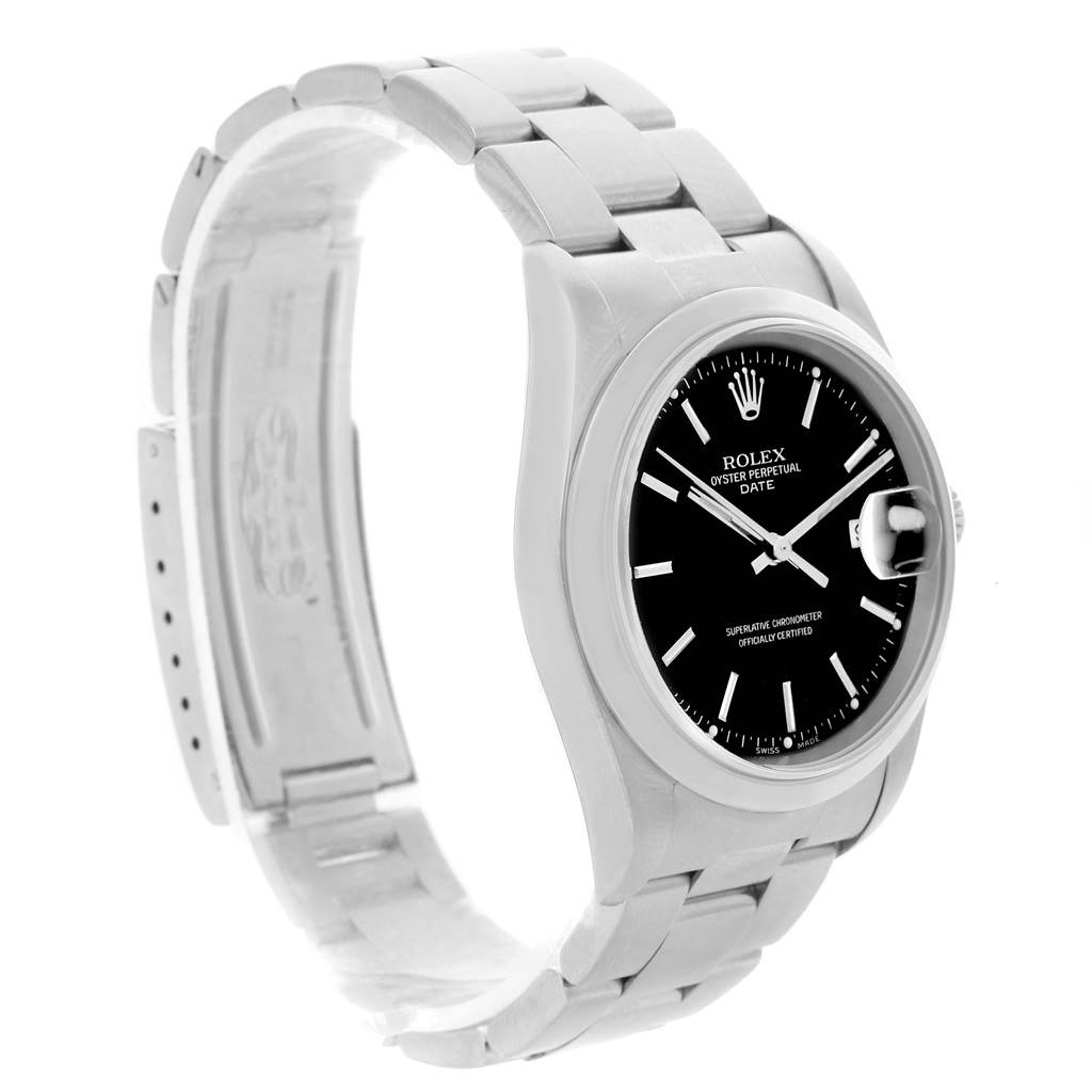 The image shows a side angle of a Rolex Oyster Perpetual Date watch, highlighting its black dial, stainless steel case, and bracelet.