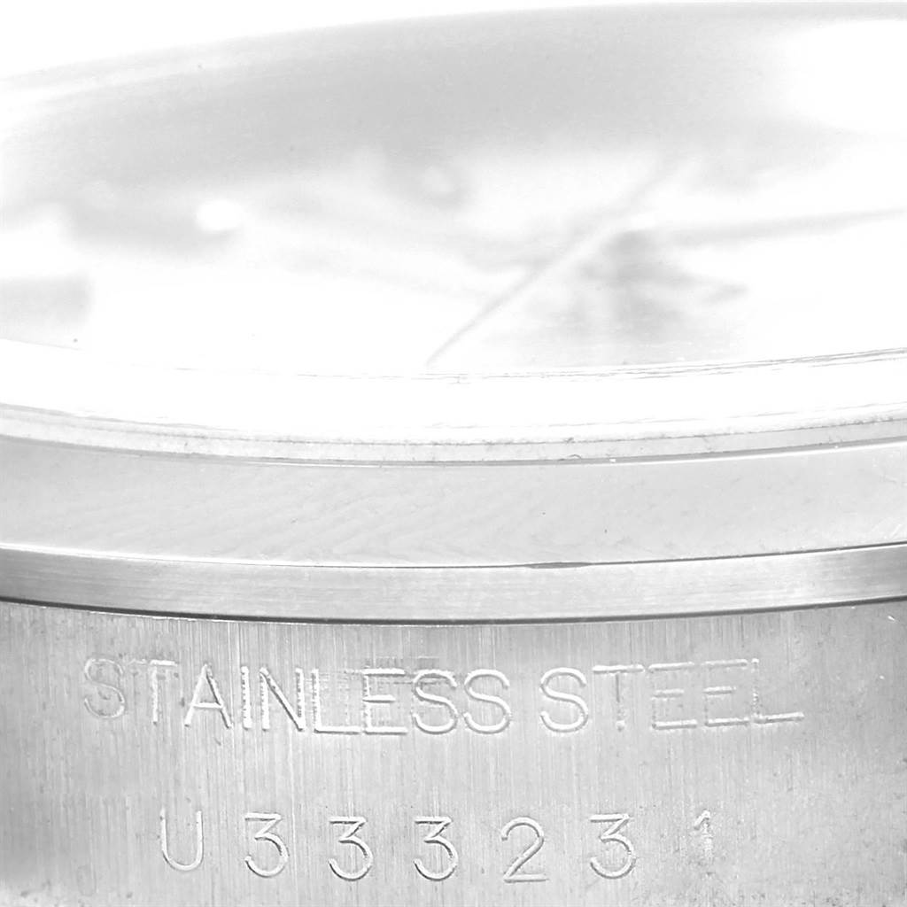 This image shows a close-up of the case back edge of a Rolex Date 15200 Men
s Stainless Steel Silver Dial 15200 Men
s Stainless Steel Silver Dial model, highlighting the stainless steel inscription and serial number.