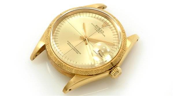 The image shows a top-side angle of a Rolex Date 1510 Men's Yellow Gold Champagne Dial 1510 Men's Yellow Gold Champagne Dial model watch, highlighting the face, crown, lugs, and crystal.