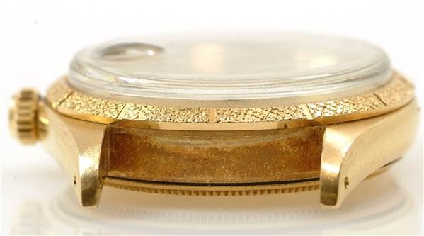 This image shows a side view of the case, bezel, and crown of a Rolex Date 1510 Men's Yellow Gold Champagne Dial 1510 Men's Yellow Gold Champagne Dial model watch.