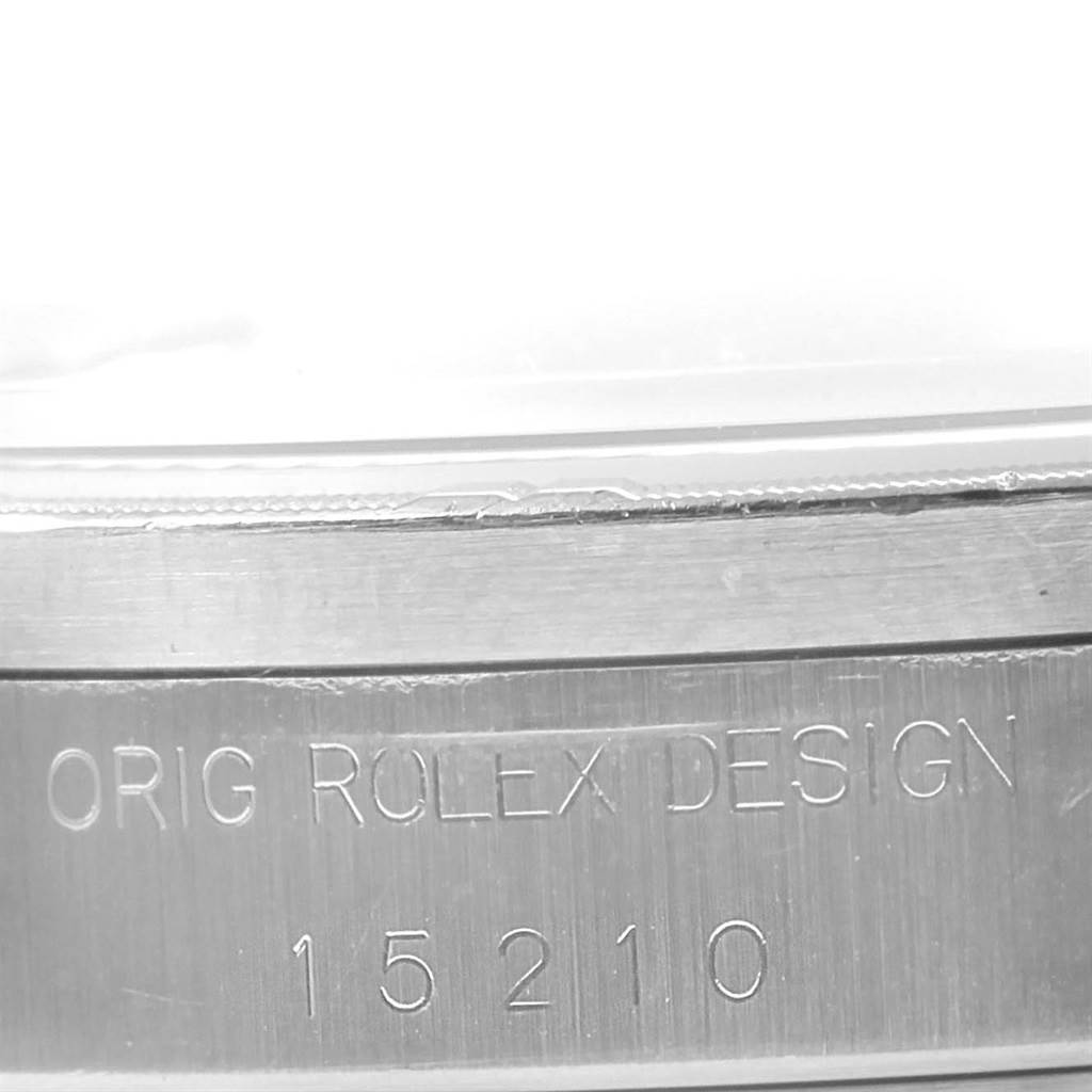 The image shows a close-up of the case side and reference number of the Rolex Date 15210 Men's Stainless Steel Silver Dial 15210 Men's Stainless Steel Silver Dial model watch.