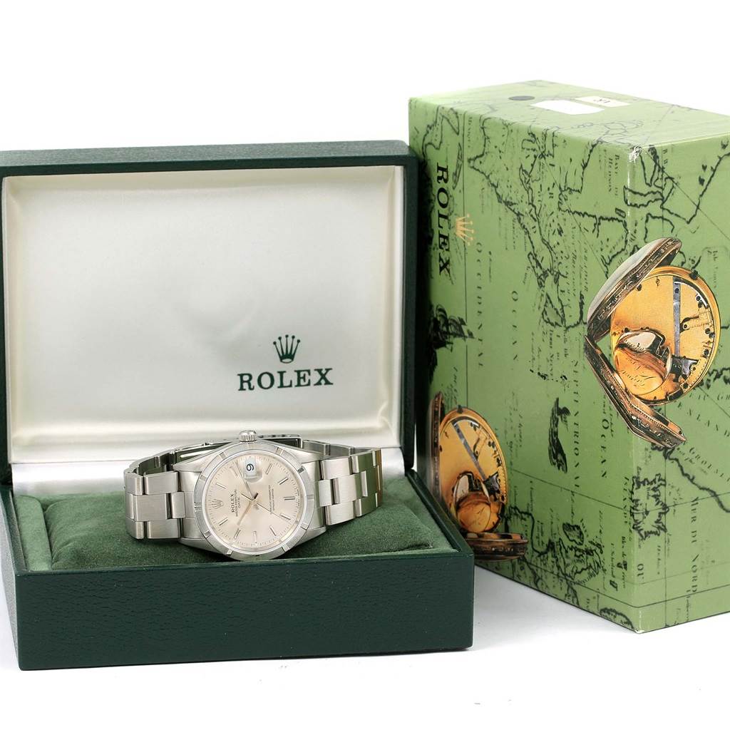 The Rolex Date 15210 Men's Stainless Steel Silver Dial 15210 Men's Stainless Steel Silver Dial watch is displayed in an open box with the original packaging next to it, viewed from the front angle.