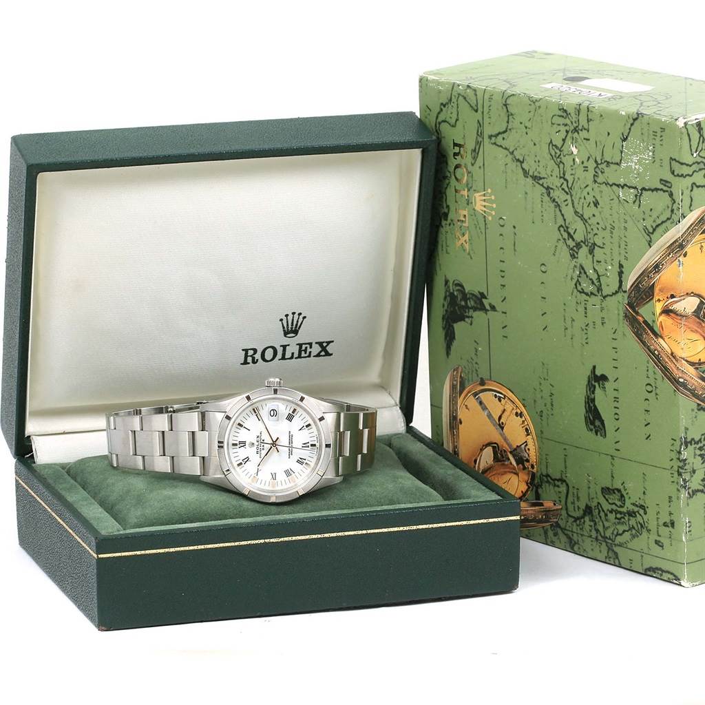 The Rolex Date 15210 Men's Stainless Steel White Dial 15210 Men's Stainless Steel White Dial model watch is shown from a front angle, inside its branded green box, next to its outer packaging.