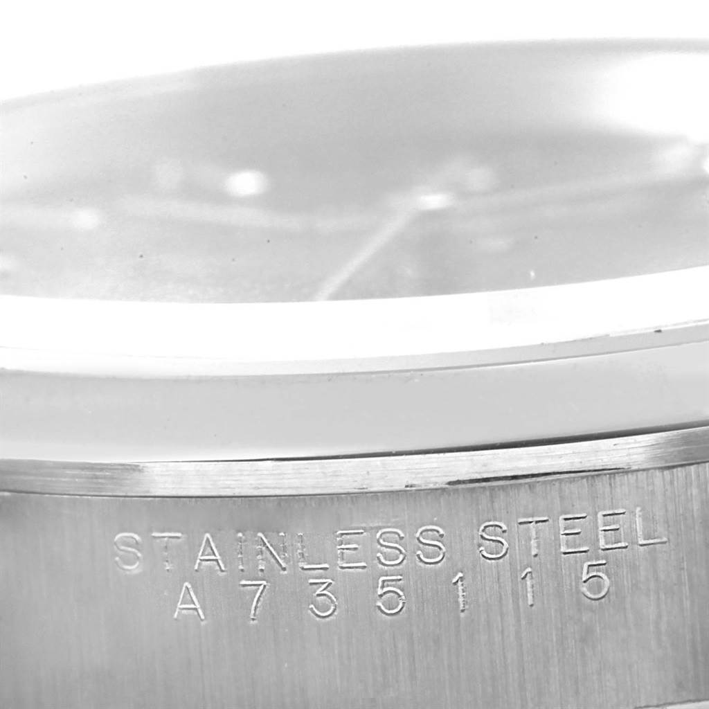 The image shows a close-up of the stainless steel case side with the serial number and part of the crystal of a Rolex Date 15200 Men's Stainless Steel Black Dial 15200 Men's Stainless Steel Black Dial model watch.