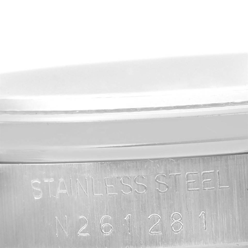 The image shows a close-up of the case back of a Rolex Date 15200 Men's Stainless Steel White Dial 15200 Men's Stainless Steel White Dial model, revealing "STAINLESS STEEL" and its serial number.