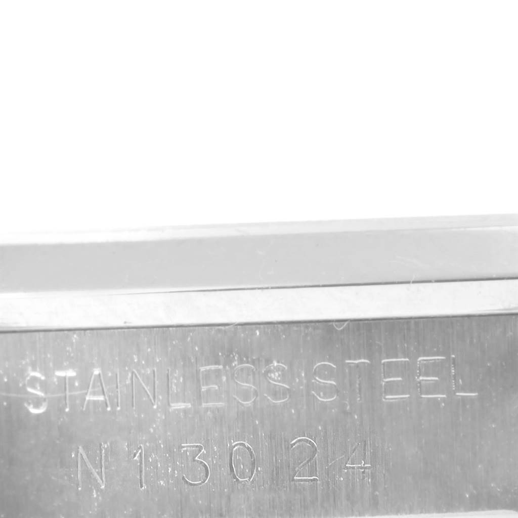 This image shows a close-up of the Rolex Date 15200 Men's Stainless Steel Silver Dial 15200 Men's Stainless Steel Silver Dial model's stainless steel case with its engraved serial number.