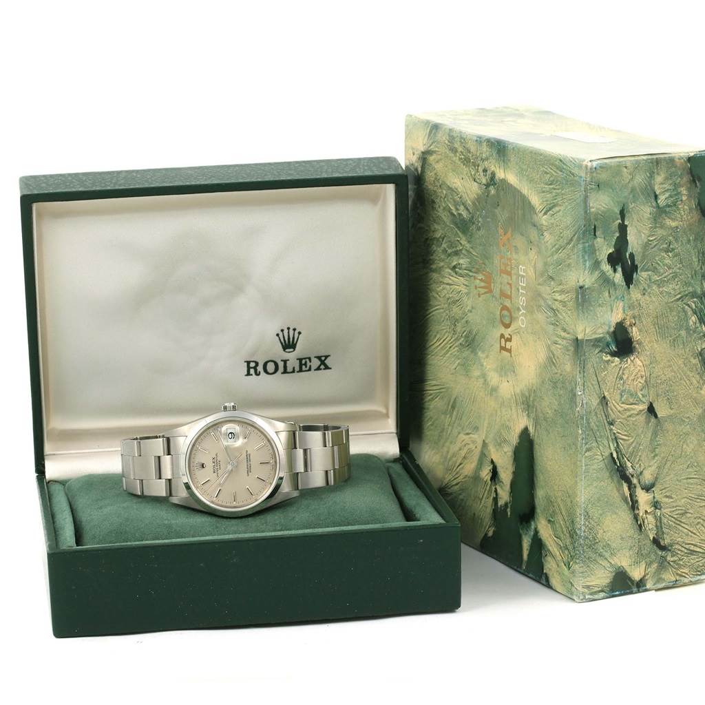 The image shows the Rolex Date 15200 Men's Stainless Steel Silver Dial 15200 Men's Stainless Steel Silver Dial model watch in its open box, revealing the watch face and band, with the outer box at the side.