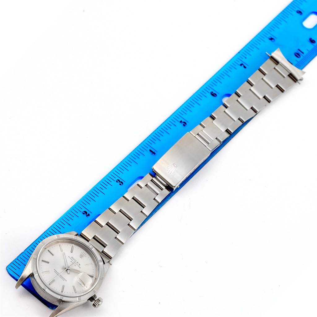 The image shows a Rolex Date 15210 Men's Stainless Steel Silver Dial 15210 Men's Stainless Steel Silver Dial watch laid flat with a blue ruler for size comparison.