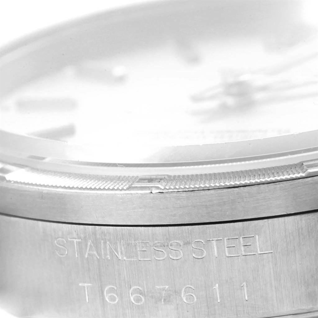 The image shows a close-up side view of the bezel, part of the crystal, and the engraved case of a Rolex Date 15210 Men's Stainless Steel Silver Dial 15210 Men's Stainless Steel Silver Dial model watch.