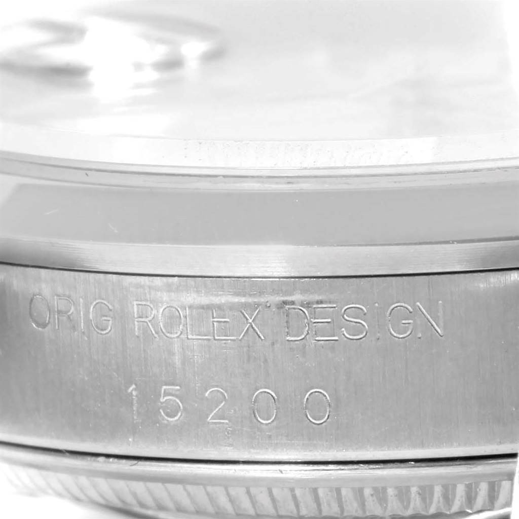 This image shows a close-up of the side of a Rolex Date 15200 Men's Stainless Steel White Dial 15200 Men's Stainless Steel White Dial model watch, focusing on the engraved text "ORIG ROLEX DESIGN" with the model number 15200.