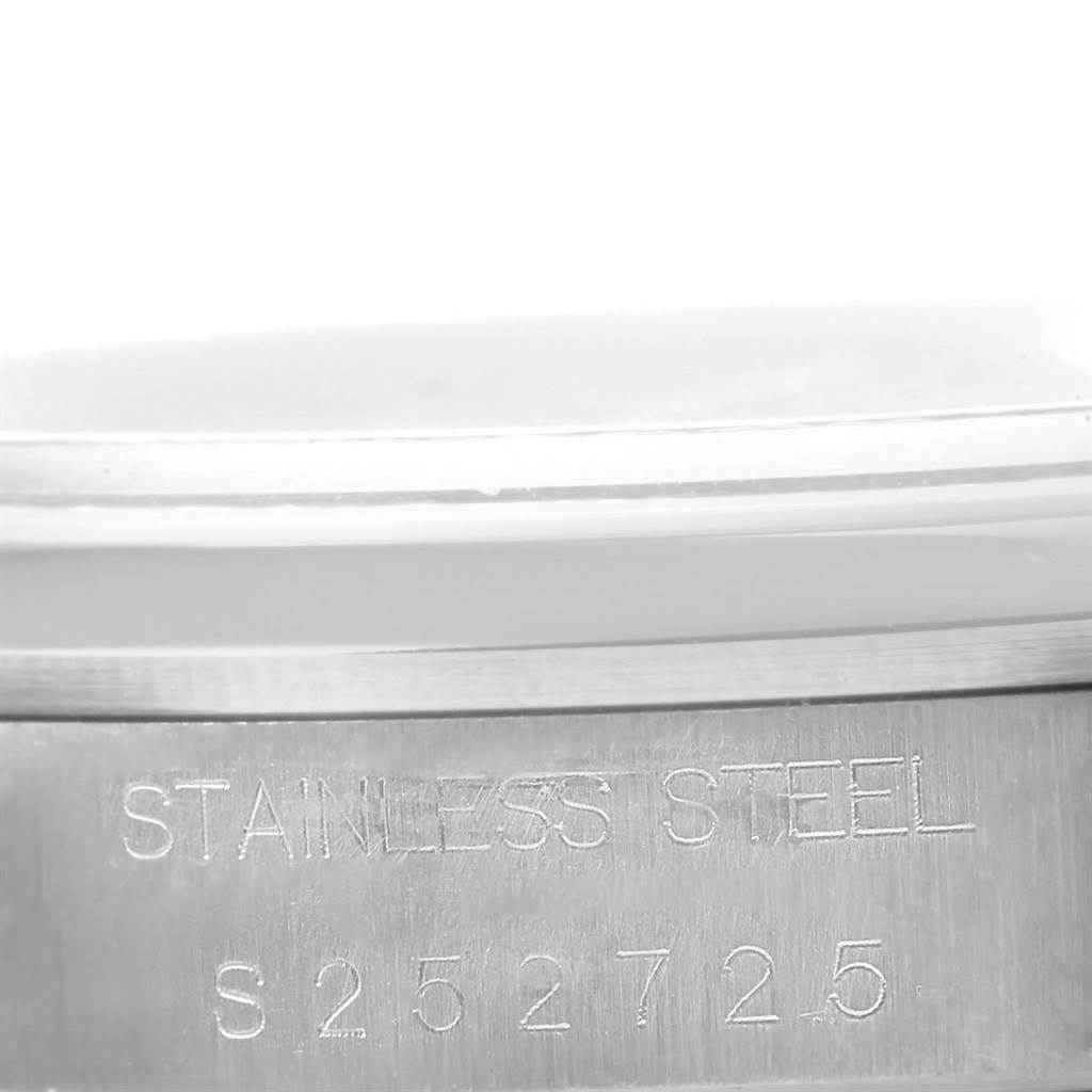 This close-up image shows the serial number and "STAINLESS STEEL" engraving on the side of a Rolex Date 15200 Men's Stainless Steel White Dial 15200 Men's Stainless Steel White Dial watch.