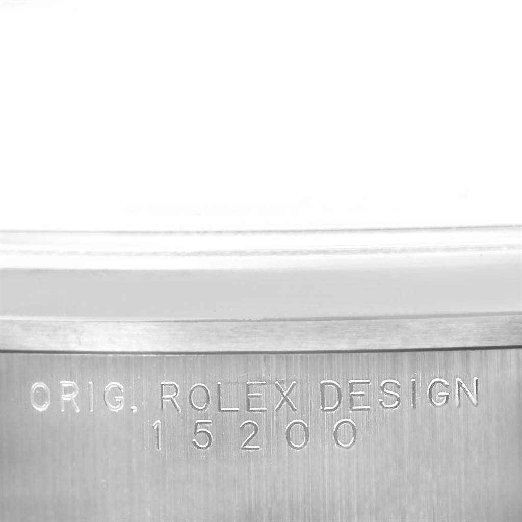 The image shows the engraved case side of the Rolex Date 15200 Men's Stainless Steel Silver Dial 15200 Men's Stainless Steel Silver Dial model with "ORIG. ROLEX DESIGN 15200" inscribed.