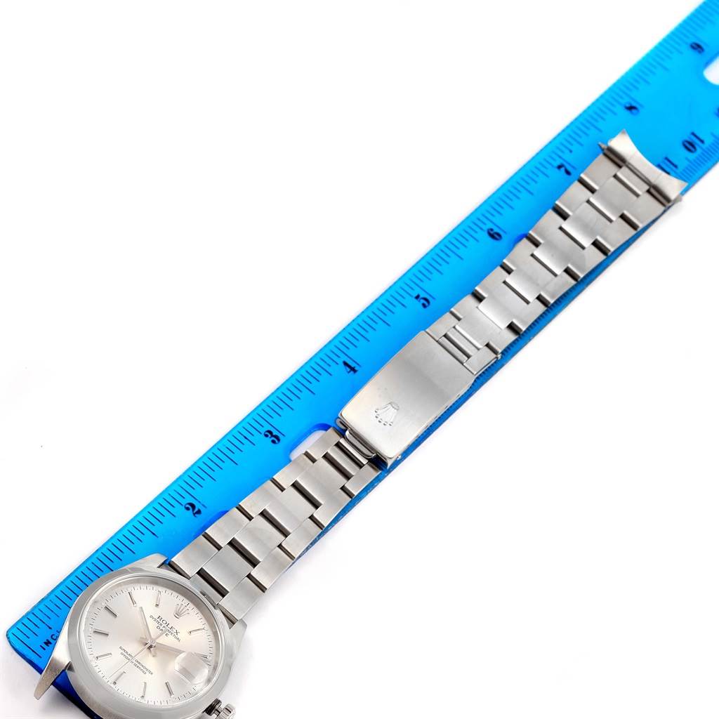 This image shows a Rolex Date 15200 Men's Stainless Steel Silver Dial 15200 Men's Stainless Steel Silver Dial model watch laid flat with a blue ruler, capturing the watch face, bracelet, and clasp.