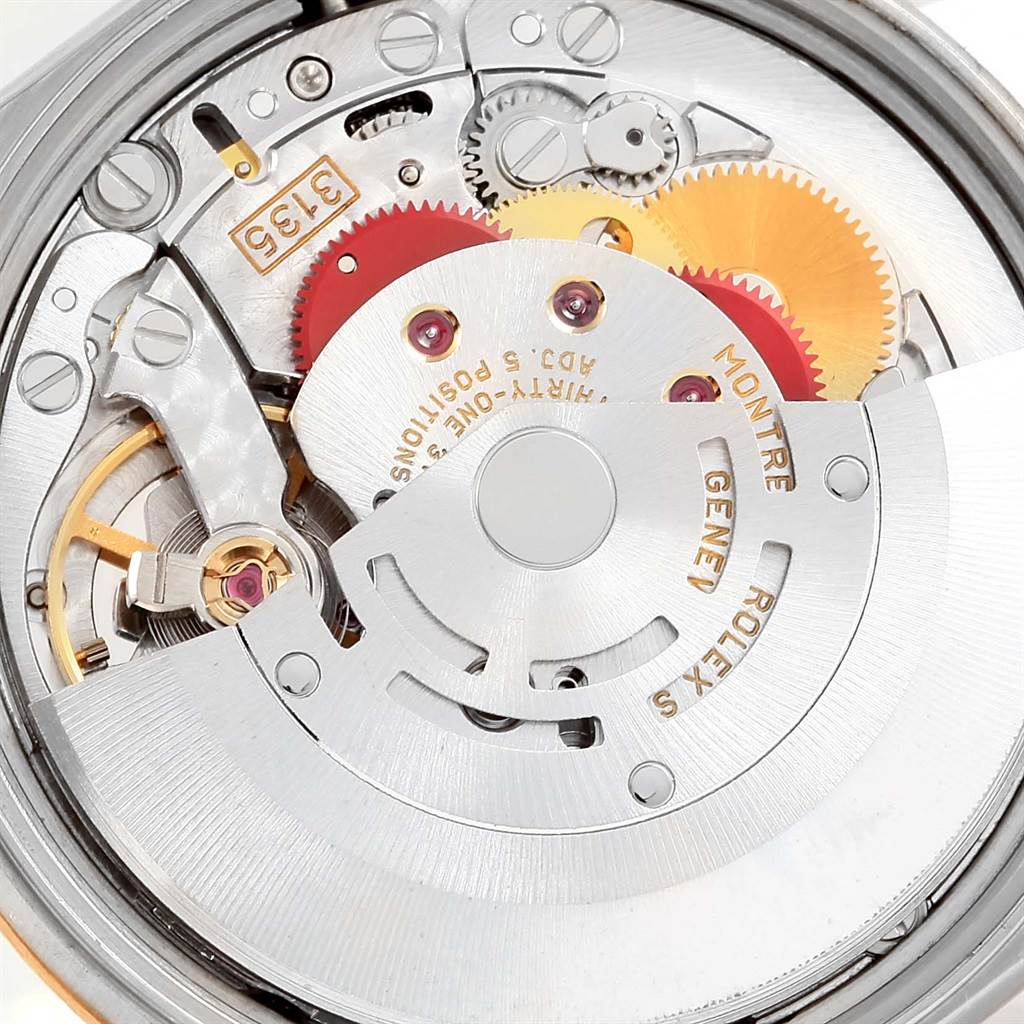 The image shows the intricate internal mechanism of a Rolex Date 15223 Men's Steel and Gold (two tone) Champagne Dial 15223 Men's Steel and Gold (two tone) Champagne Dial model watch, showcasing its gears and rotor.
