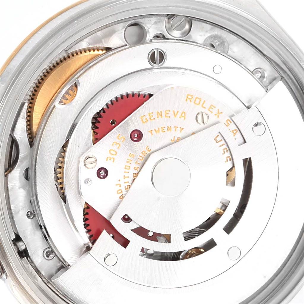 This is a close-up view of the movement mechanism of a Rolex Date 15053 Men's Steel and Gold (two tone) Champagne Dial 15053 Men's Steel and Gold (two tone) Champagne Dial watch, showing gears, jewels, and the rotor.