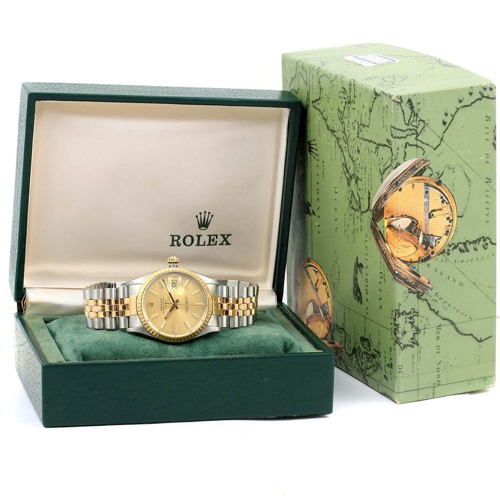 The image shows a Rolex Date 15053 Men's Steel and Gold (two tone) Champagne Dial 15053 Men's Steel and Gold (two tone) Champagne Dial watch positioned in an open green box next to a matching decorative box.