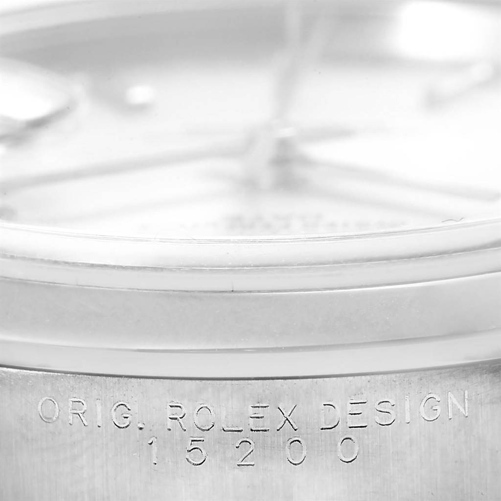 The image shows a close-up angle of a Rolex Date 15200 Men's Stainless Steel Silver Dial 15200 Men's Stainless Steel Silver Dial model watch, focusing on the engraving "ORIG. ROLEX DESIGN 15200".