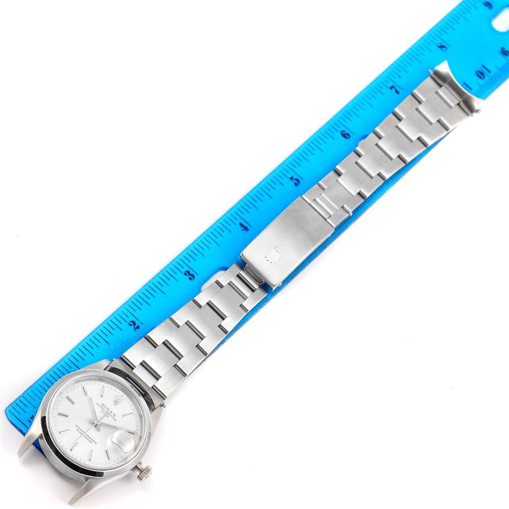 The image shows a laid-flat Rolex Date 15200 Men's Stainless Steel Silver Dial 15200 Men's Stainless Steel Silver Dial model watch with its bracelet measured against a blue ruler.