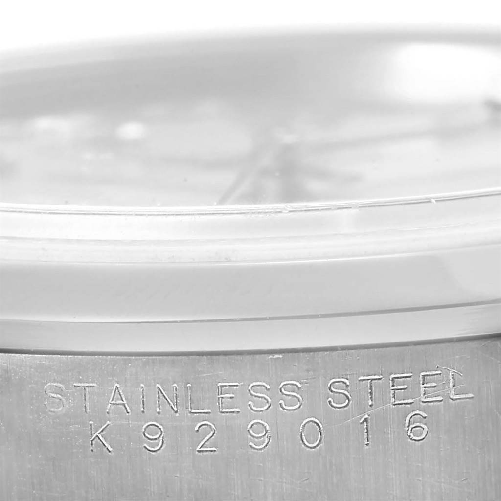The image shows a close-up of the side of a Rolex Date 15200 Men's Stainless Steel Silver Dial 15200 Men's Stainless Steel Silver Dial model watch, highlighting the stainless steel material and serial number.