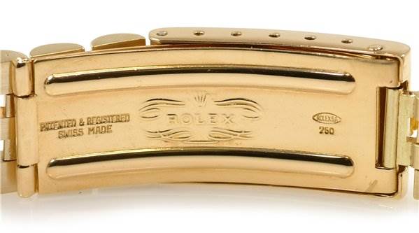 This image shows the clasp of a Rolex Date 15238 Men's Yellow Gold Blue Dial 15238 Men's Yellow Gold Blue Dial model watch, displaying the brand engraving and Swiss Made inscriptions.