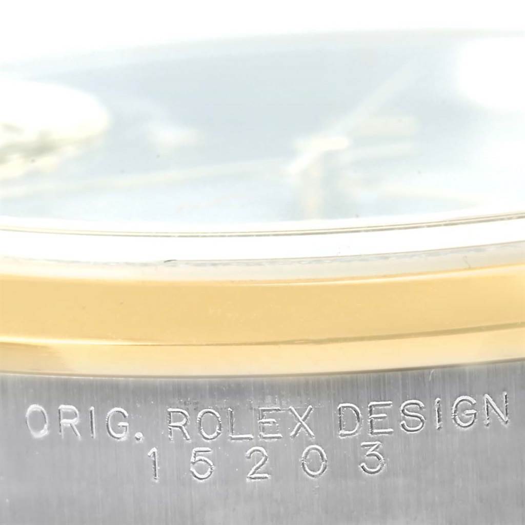 This close-up image shows the side view of the Rolex Date 15203 Men's Steel and Gold (two tone) Grey Dial 15203 Men's Steel and Gold (two tone) Grey Dial model with the original design number 15203 engraved.