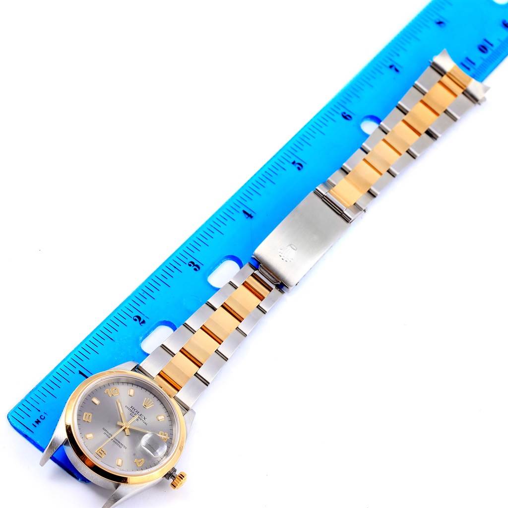 The image shows a Rolex Date 15203 Men's Steel and Gold (two tone) Grey Dial 15203 Men's Steel and Gold (two tone) Grey Dial watch lying flat, with its face, bezel, and two-tone bracelet visible alongside a blue ruler.