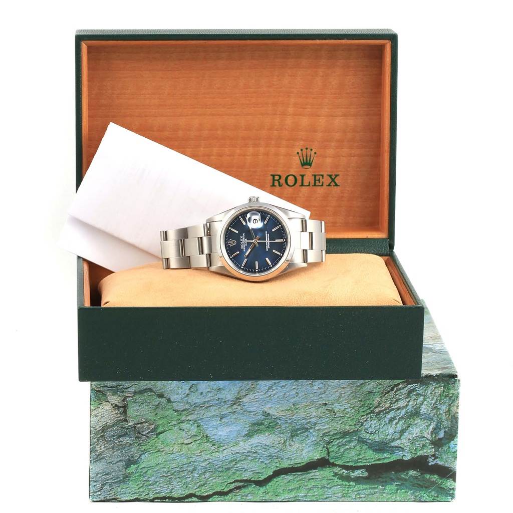 The Rolex Date 15200 Men's Stainless Steel Blue Dial 15200 Men's Stainless Steel Blue Dial model watch is shown from the front, displayed in its open box with accompanying papers.