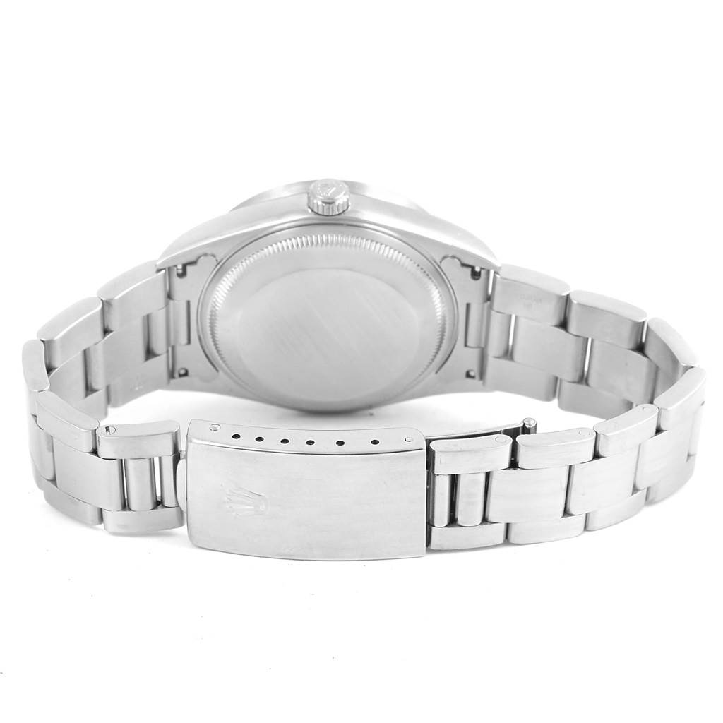 The image shows the back view of a Rolex Date 15210 Men's Stainless Steel Black Dial 15210 Men's Stainless Steel Black Dial model watch, highlighting its clasp, bracelet, and case back.