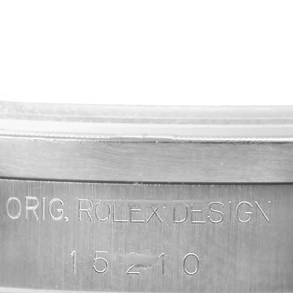 This image shows a close-up of the engraving on the side of a Rolex Date 15210 Men's Stainless Steel Black Dial 15210 Men's Stainless Steel Black Dial model watch case.