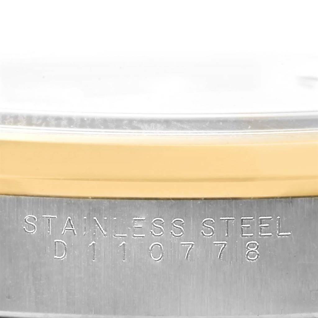 This image shows a close-up of the case side and bezel of a Rolex Date 15203 Men's Steel and Gold (two tone) Black Dial 15203 Men's Steel and Gold (two tone) Black Dial watch, with visible engraving.