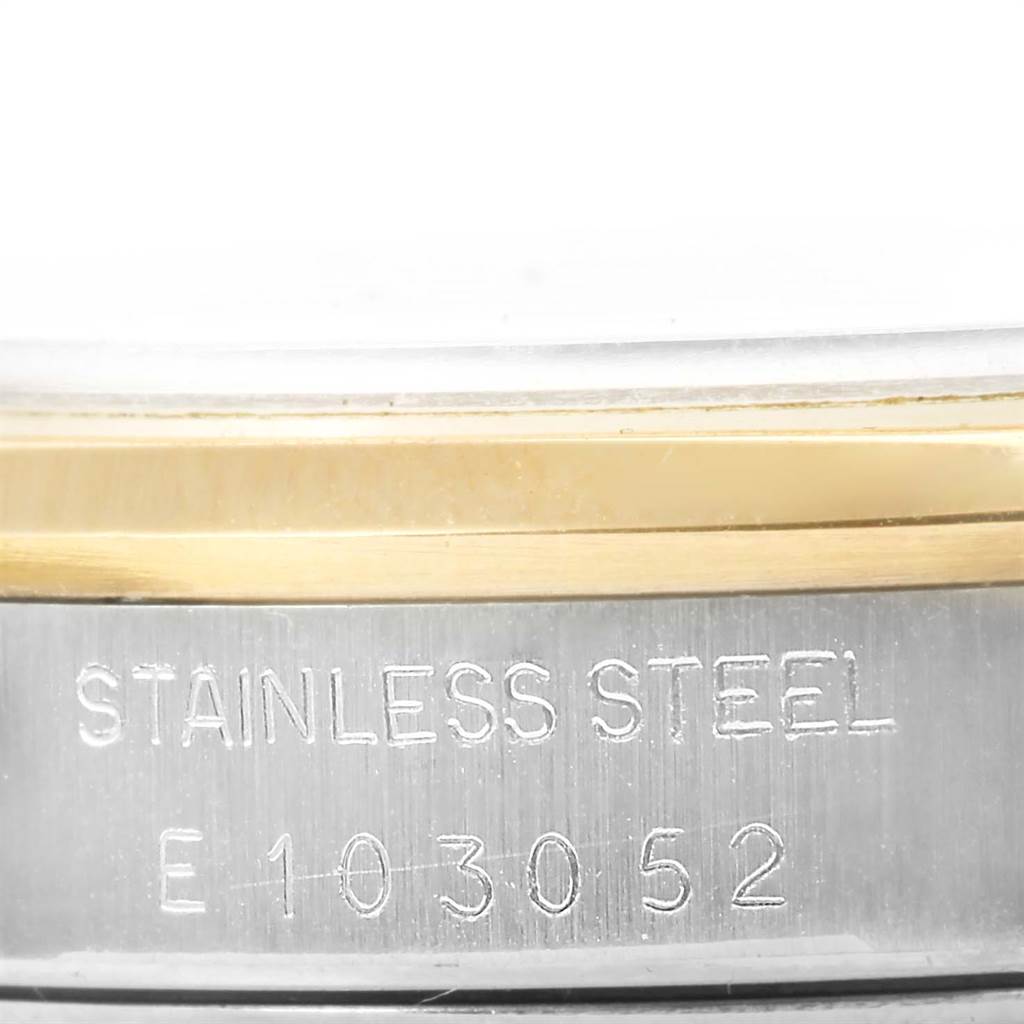 This close-up image shows the side of the stainless steel case and part of the bezel of a Rolex Date 15203 Men's Steel and Gold (two tone) Silver Dial 15203 Men's Steel and Gold (two tone) Silver Dial watch.