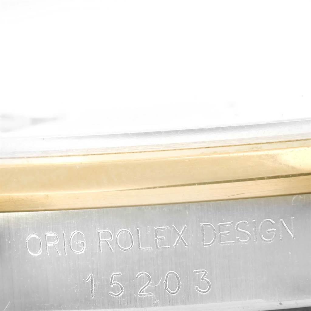 The image shows a close-up of the case side of a Rolex Date 15203 Men's Steel and Gold (two tone) Silver Dial 15203 Men's Steel and Gold (two tone) Silver Dial model, displaying the engraving "ORIG ROLEX DESIGN 15203."
