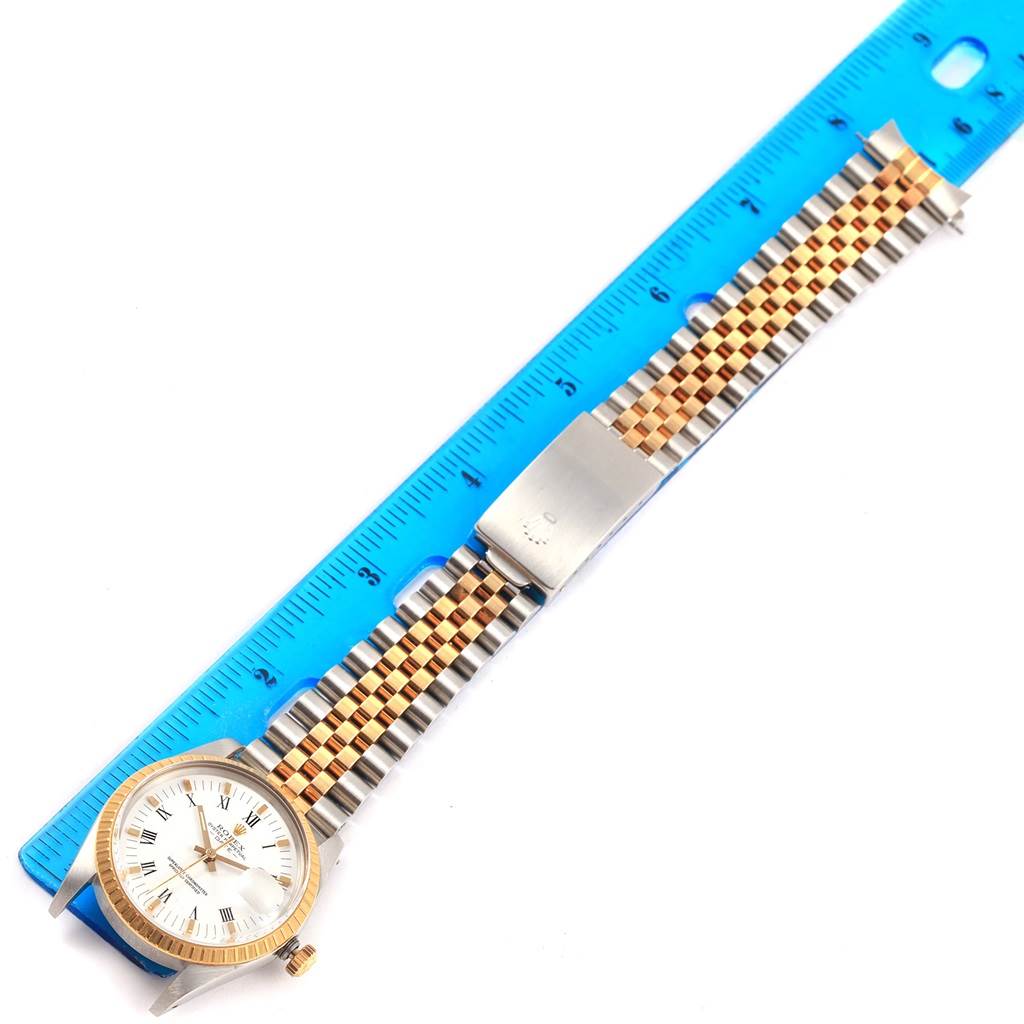 The watch, a Rolex Date 15053 Men's Steel and Gold (two tone) White Dial 15053 Men's Steel and Gold (two tone) White Dial model, is shown at a horizontal angle, displaying the dial, bezel, crown, and two-tone bracelet beside a ruler.