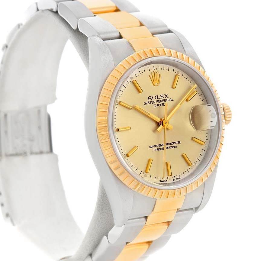 The image shows a side view of the Rolex Date 15223 Men's Steel and Gold (two tone) Champagne Dial 15223 Men's Steel and Gold (two tone) Champagne Dial watch, highlighting its dial, fluted bezel, and two-tone bracelet.