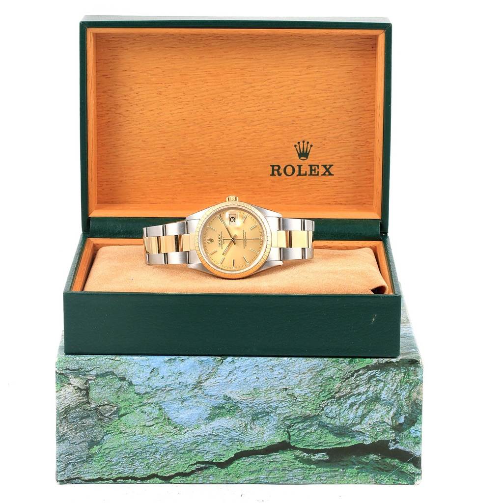 The Rolex Date 15223 Men's Steel and Gold (two tone) Champagne Dial 15223 Men's Steel and Gold (two tone) Champagne Dial model watch is displayed frontally, inside its branded box with the lid open.